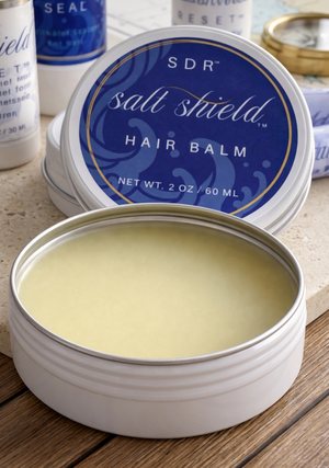 Open 2 oz tin of Salt Shield Pre-Dive Hair Balm with blue label